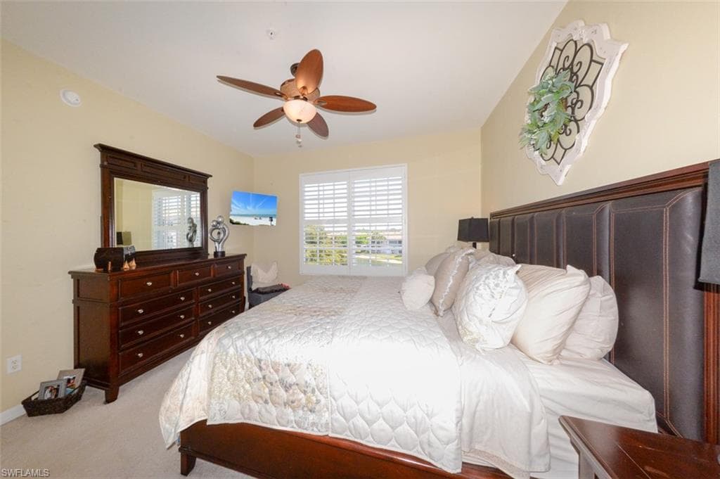 Spacious Primary Suite features large windows with Lake View, Plantation Shutters, En-suite bathroom & Large walk-in closet.