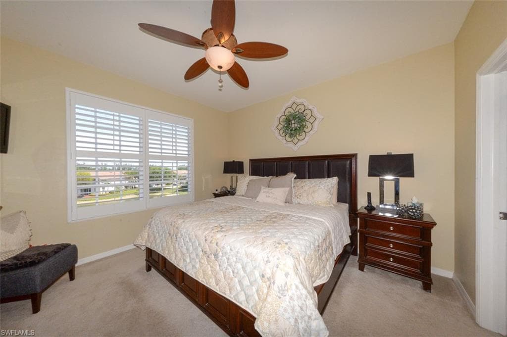 Spacious Primary Suite features large windows with Lake View, Plantation Shutters, En-suite bathroom & Large walk-in closet.