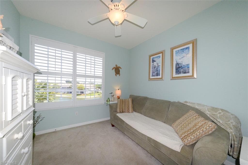Guest bedroom with closet, Plantation shutters and view of Lake. Currently used as den with sleeper sofa.