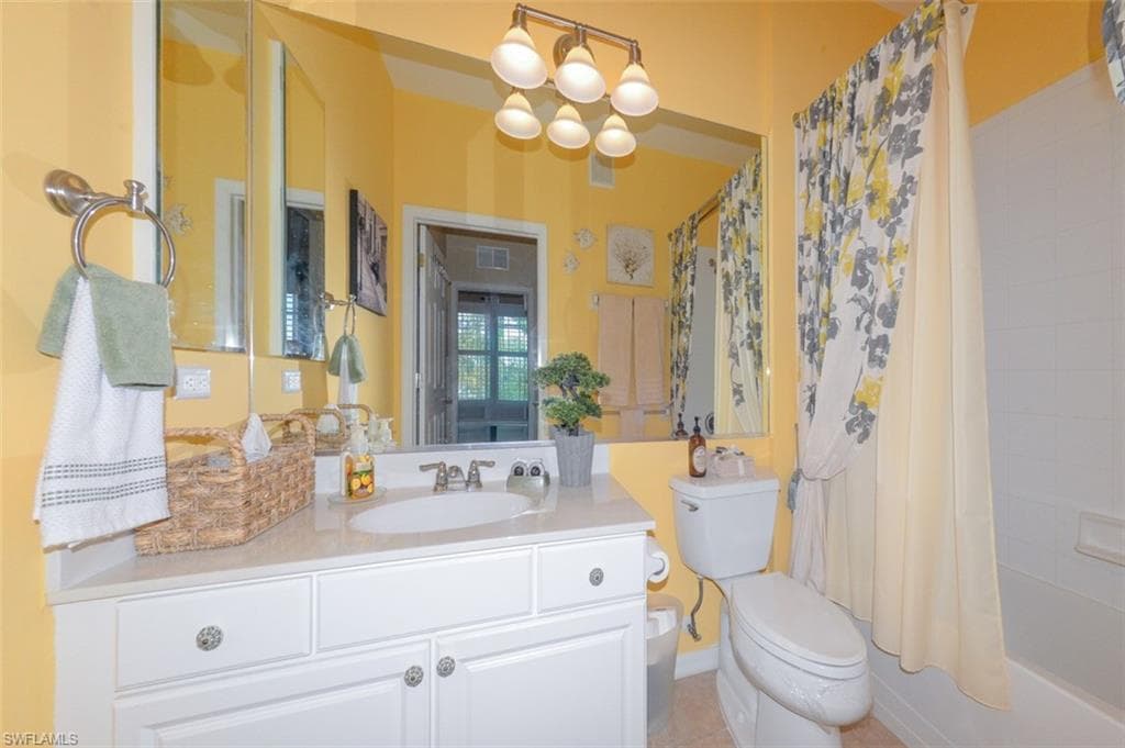 Guest Bathroom with full tub and shower, Tiled floor and upgraded lighting.