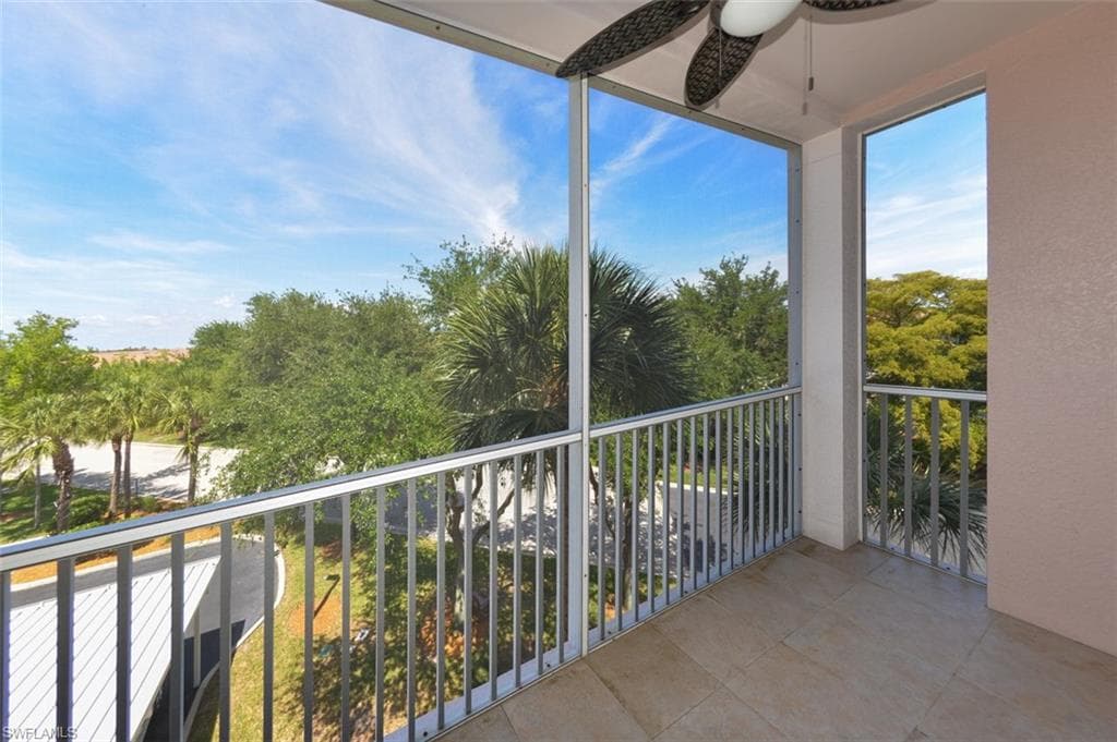 Covered and screened Lanai with view of Landscaped area and trees.