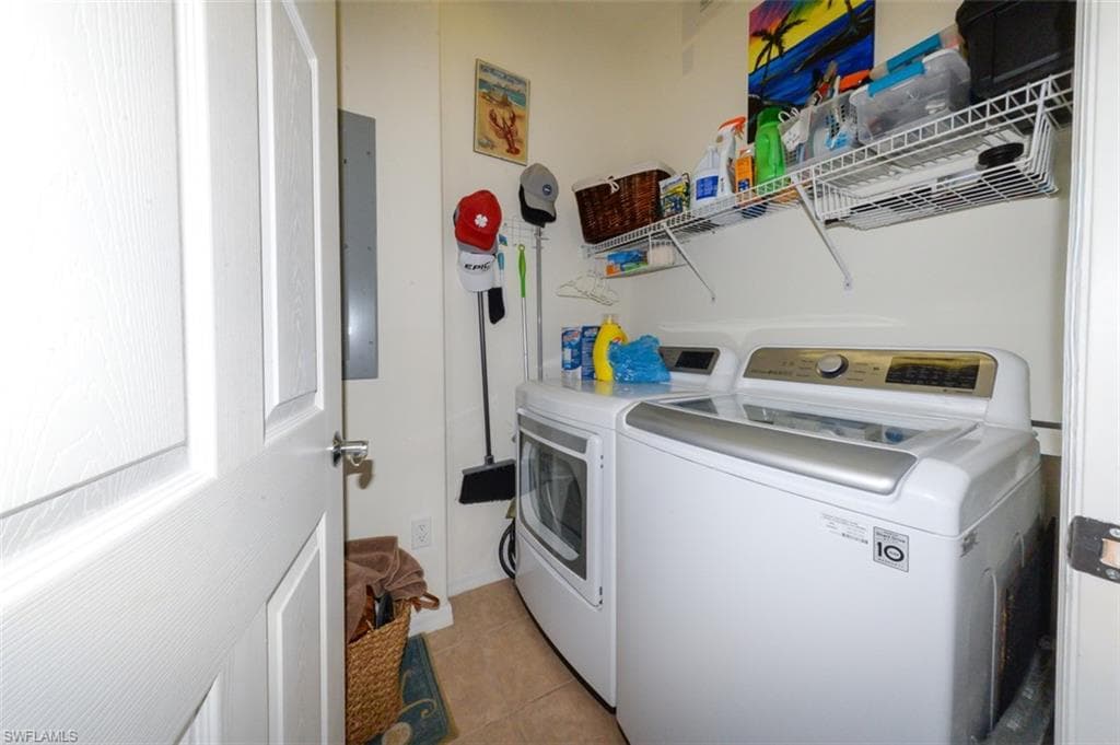 Laundry room with storage and tiled floor.