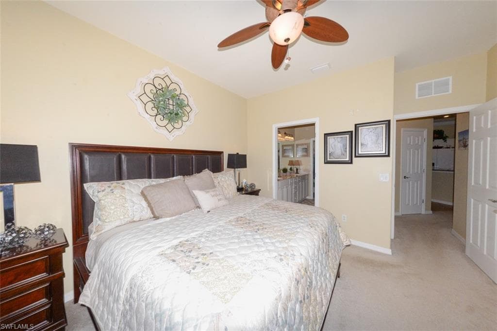 Spacious Primary Suite features large windows with Lake View, Plantation Shutters, En-suite bathroom & Large walk-in closet.