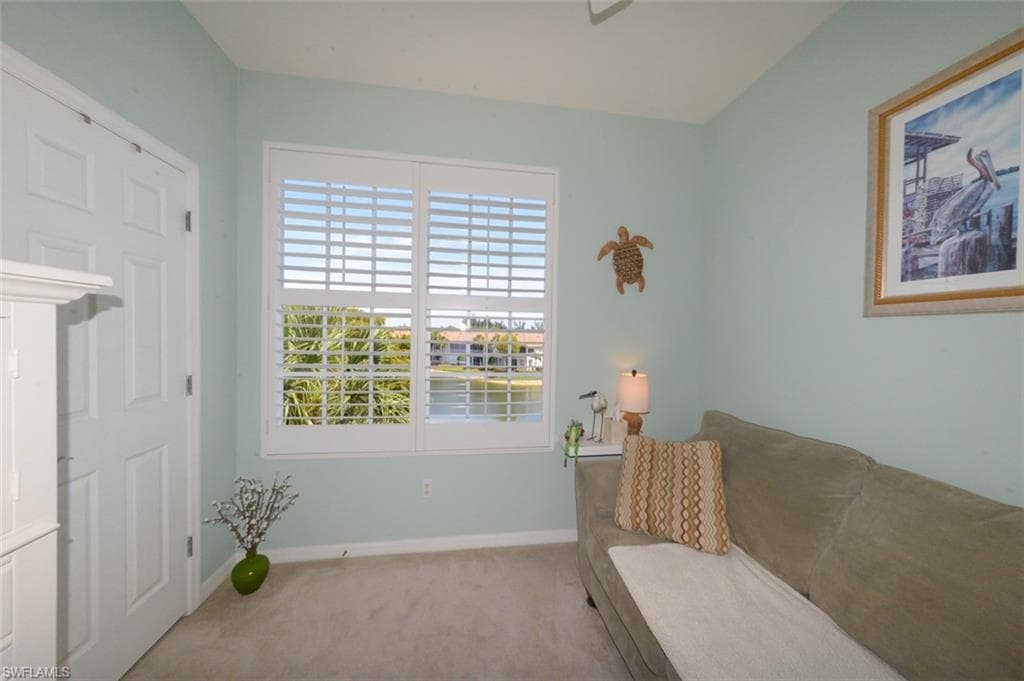 Guest bedroom with Plantation shutters, closet and view of Lake. Currently used as den with sleeper sofa.