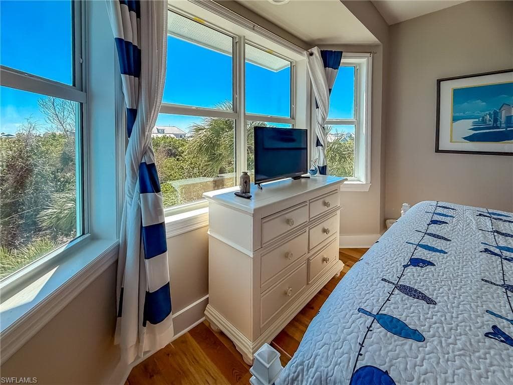 Bedroom with baseboards and wood finished floors