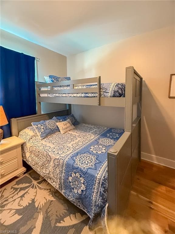 Bedroom featuring baseboards and wood finished floors