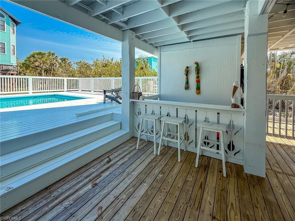 Wooden deck with a fenced in pool