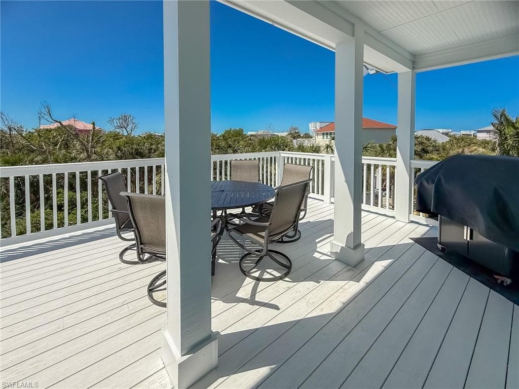 Wooden terrace featuring outdoor dining area