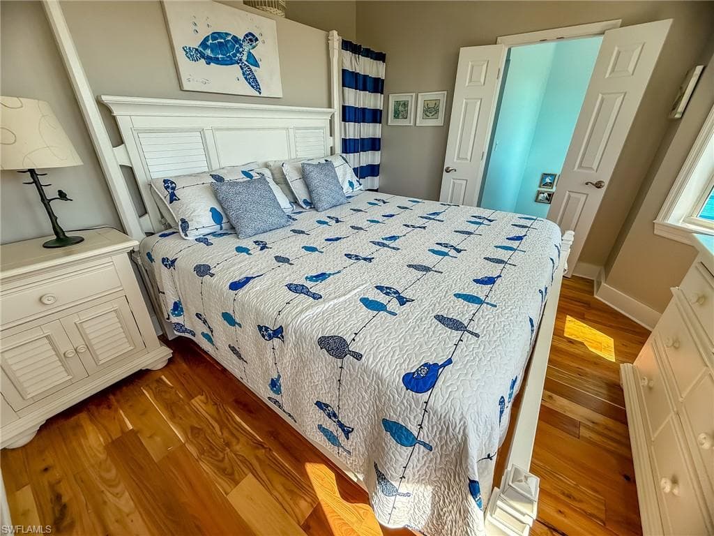 Bedroom with baseboards and wood finished floors
