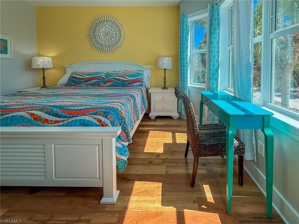 Bedroom featuring wood finished floors and baseboards