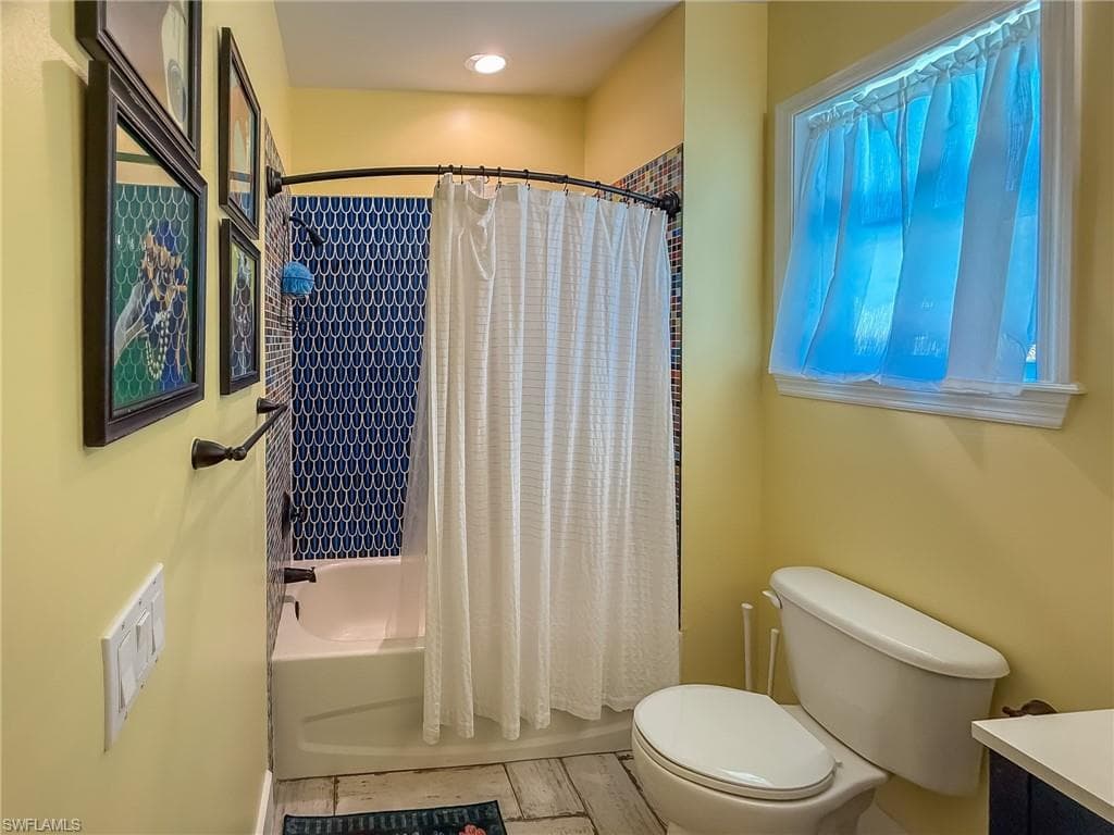 Full bathroom featuring toilet and shower / bath combo