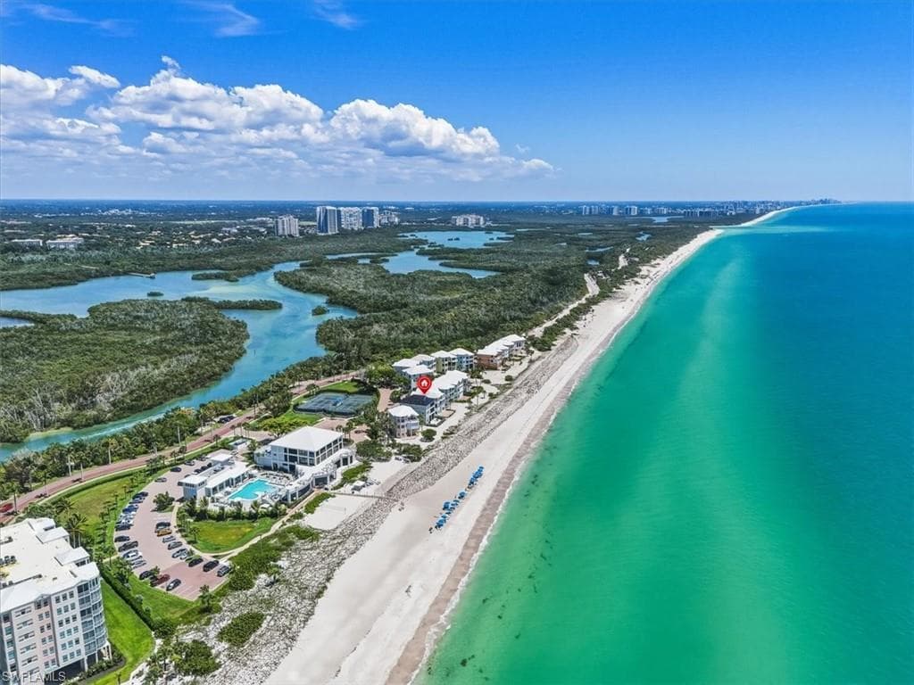 Coastal property featuring direct beach frontage, expansive white sand shoreline, and clear turquoise waters