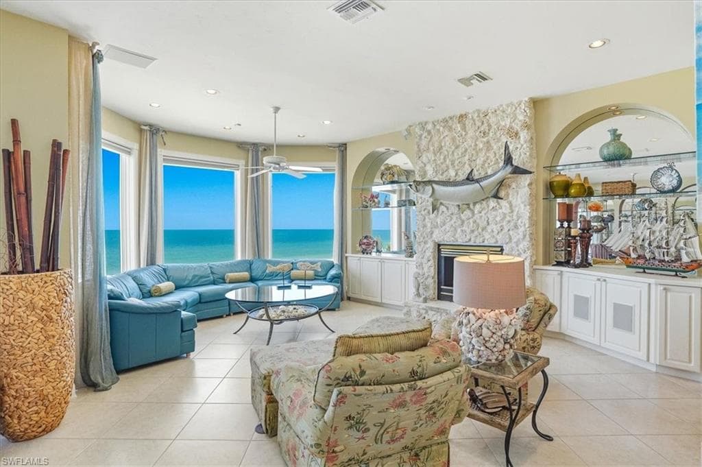 Expansive living area featuring large bay windows overlooking the ocean