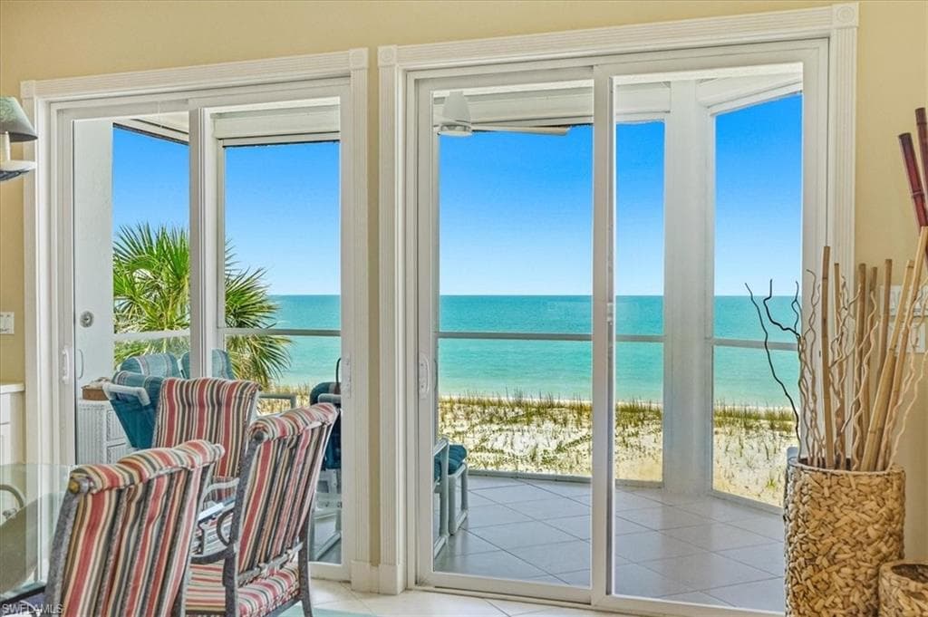 Expansive sliding glass doors provide access to a private balcony