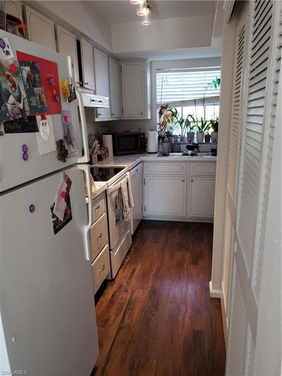 Kitchen from living room with double doors on right that are your pantry
