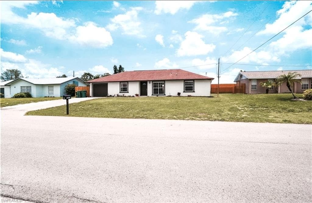 Ranch-style house with driveway and a garage