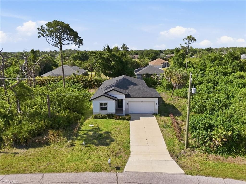 Single-story residence featuring a white exterior and a dark shingle roof