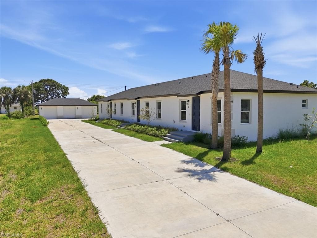Contemporary white stucco exterior with a dark shingle roof, featuring a concrete driveway and three palm trees