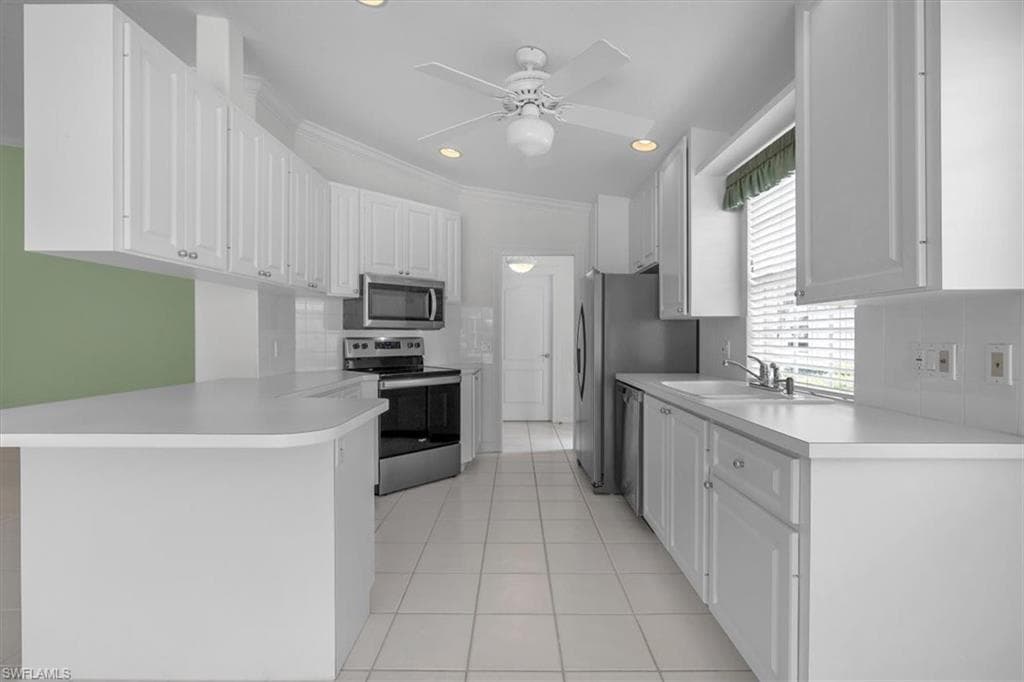 Clean and bright kitchen with appliances replaced with stainless steel.