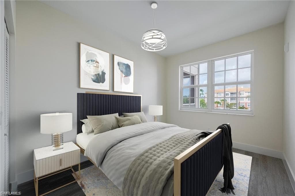 Bedroom with baseboards and wood finished floors