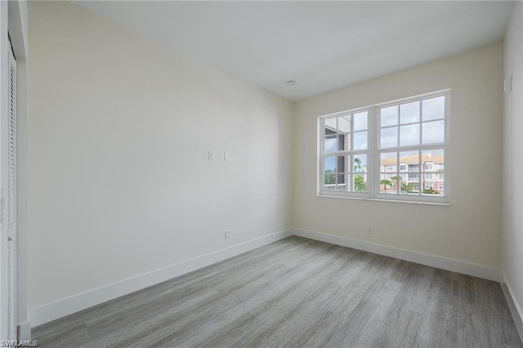 Empty room featuring baseboards and wood finished floors