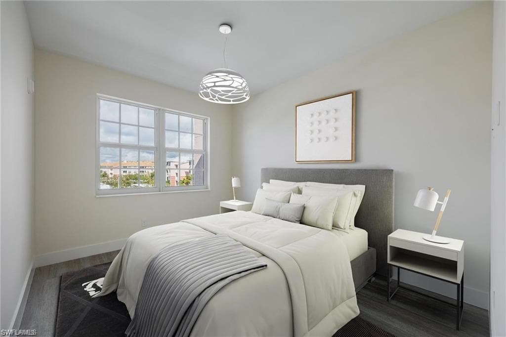 Bedroom featuring baseboards and dark wood finished floors