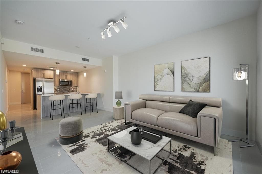 Living area with baseboards, visible vents, recessed lighting, and light tile patterned flooring