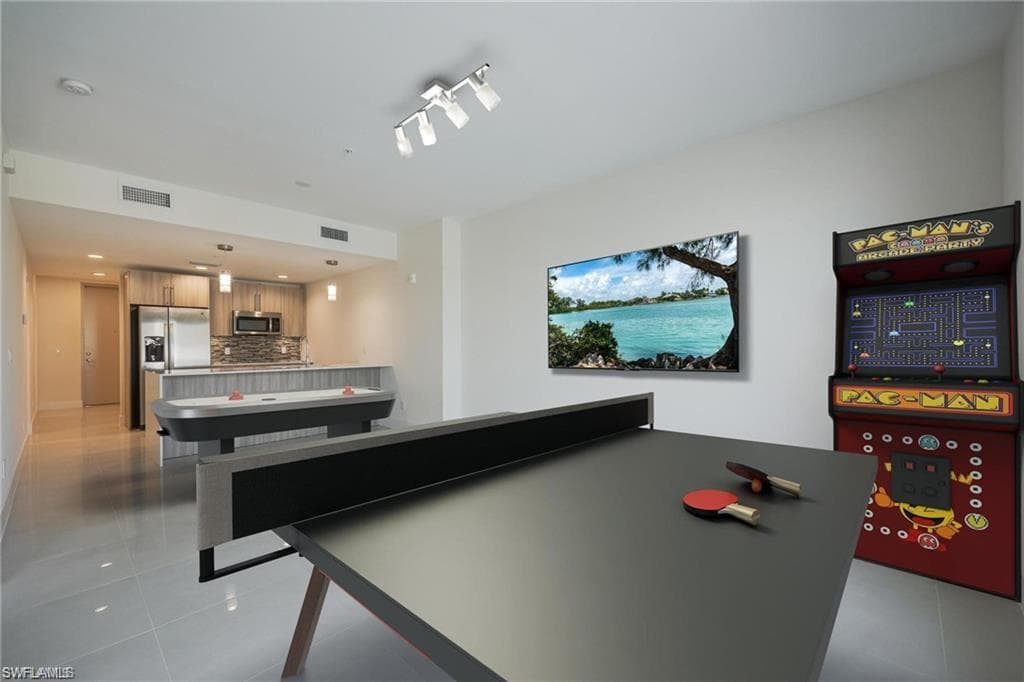Playroom featuring visible vents and light tile patterned floors