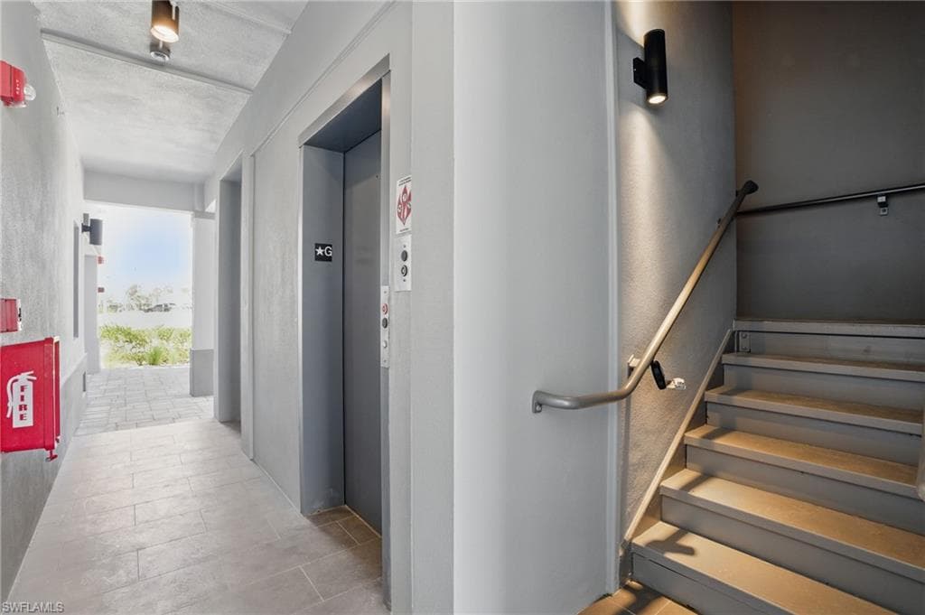 Ground Level Entry Hall featuring Elevator + Stairwell - VIRTUALLY EDITED
