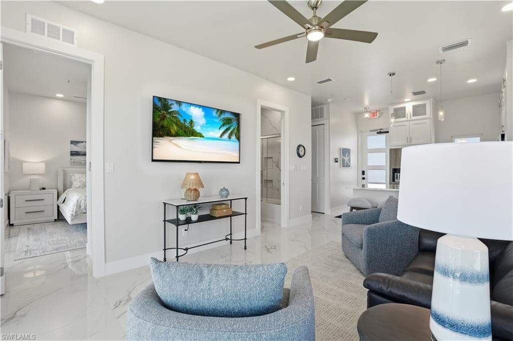Living area with light marble finish flooring, ceiling fan, and recessed lighting - Virtually Edited Image