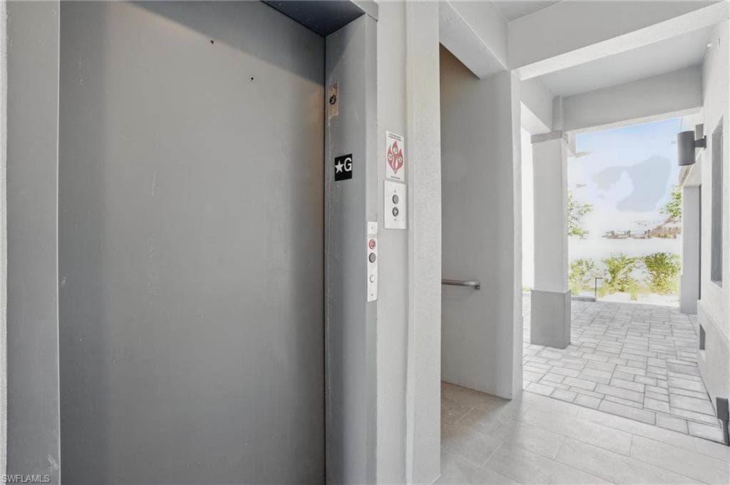 Ground Level Entry Hall featuring Elevator + Stairwell - VIRTUALLY EDITED