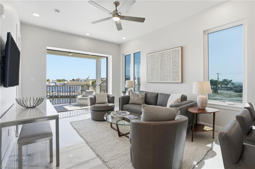 Living room featuring a ceiling fan and recessed lighting - Virtually Edited Image