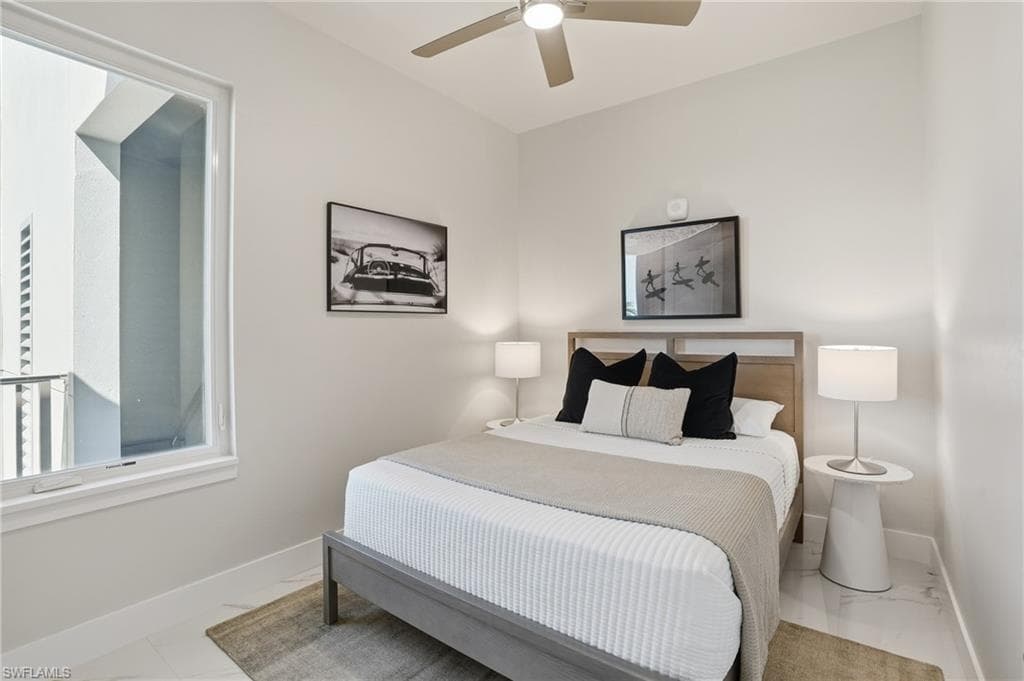 Bedroom featuring baseboards and ceiling fan - Virtually Edited Image