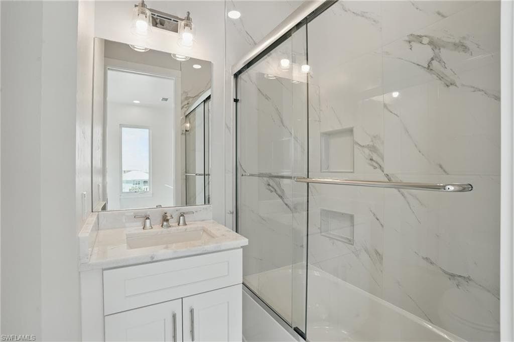 Guest bath featuring combined bath / shower with glass door and vanity - VIRTUALLY EDITED
