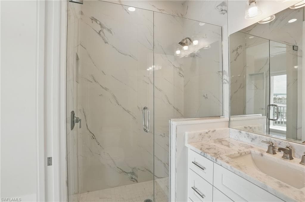 Master Bathroom featuring a marble finish shower and vanity - VIRTUALLY EDITED