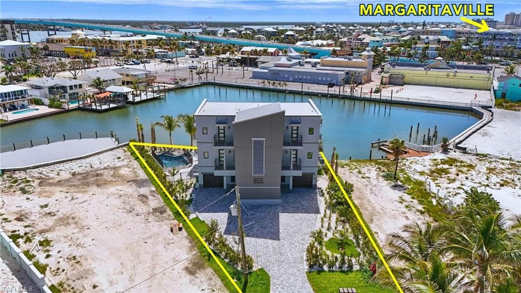 Aerial overview of property's location with property parcel outlined and lagoon front - VIRTUALLY EDITED
