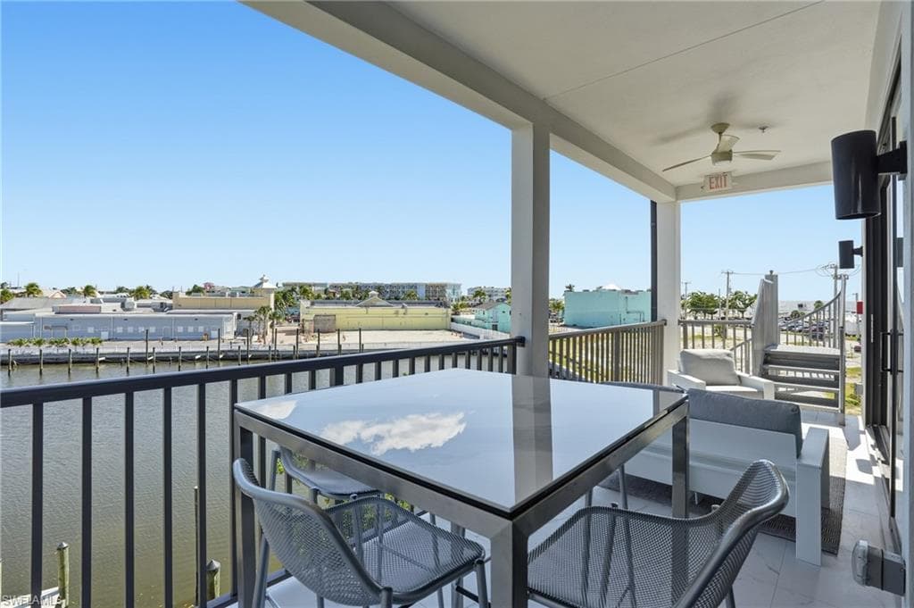 Balcony with a water view and outdoor dining area - Virtually Edited Image