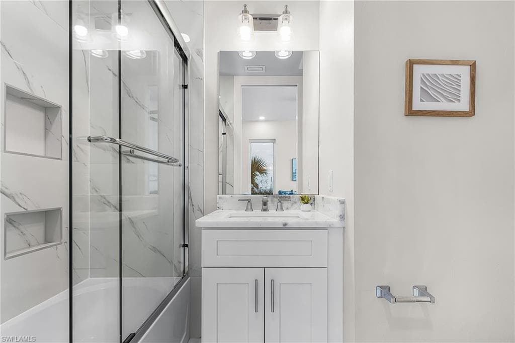 Bathroom featuring a single vanity with a white countertop and under-mount sink - Virtually Edited Image