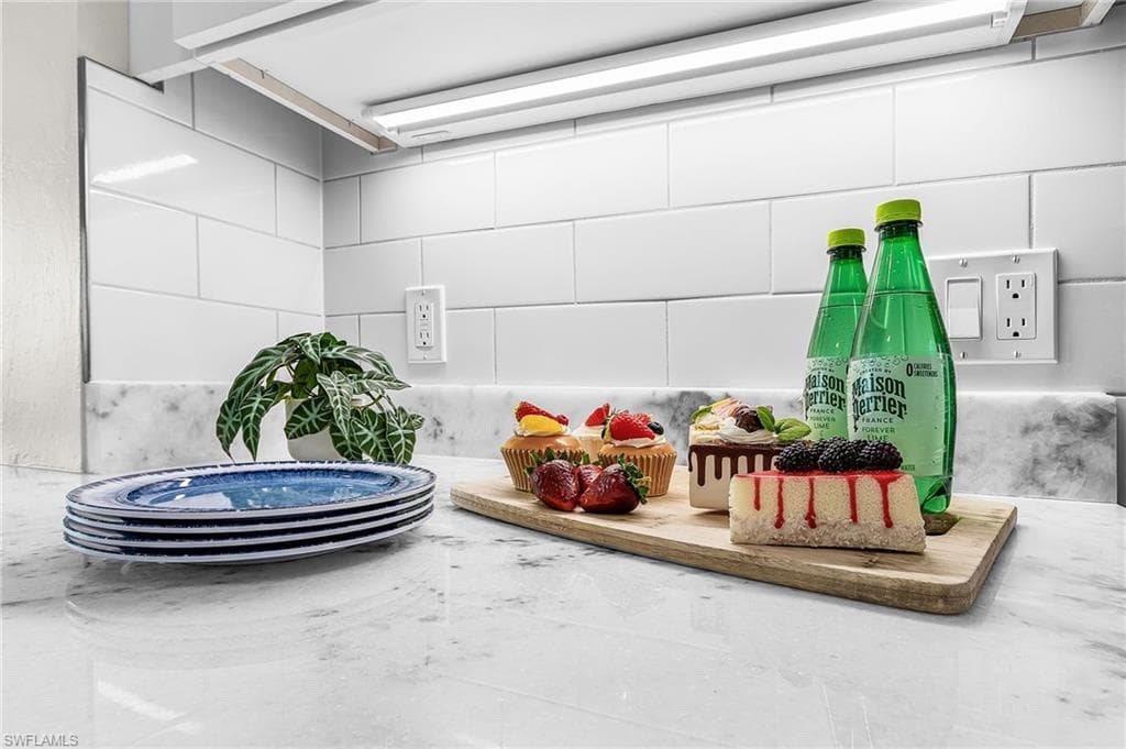 Polished countertop with a subtle veined pattern, complemented by a white subway tile backsplash - Virtually Edited Image