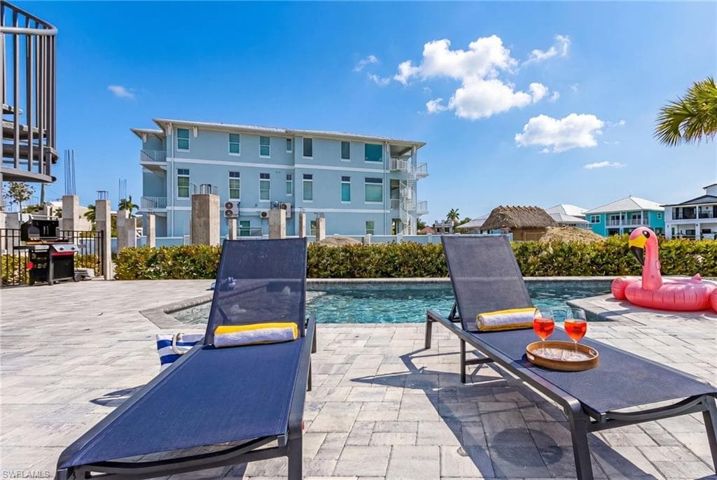Pool deck featuring large format pavers and a built-in swimming pool - Virtually Edited Image