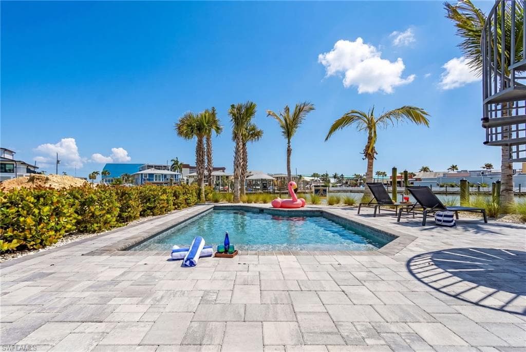 Private swimming pool surrounded by a paver patio - Virtually Edited Image