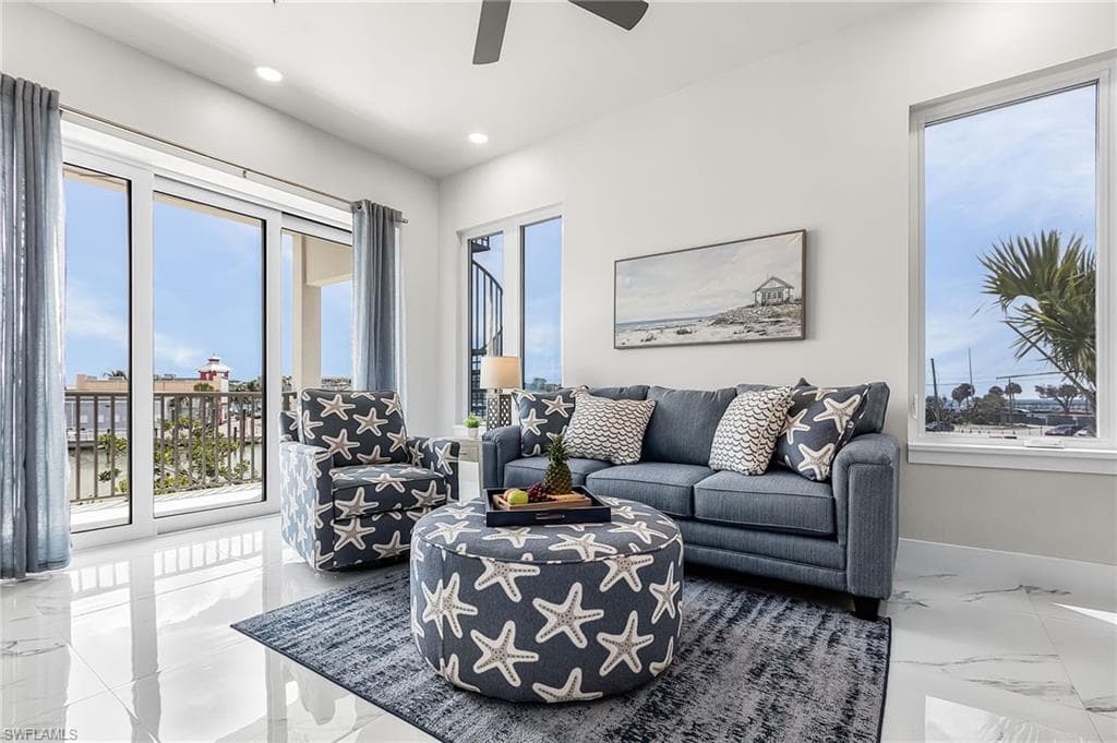 Spacious living area featuring polished tile flooring, abundant natural light from large windows, and direct access to an outdoor balcony - Virtually Edited Image