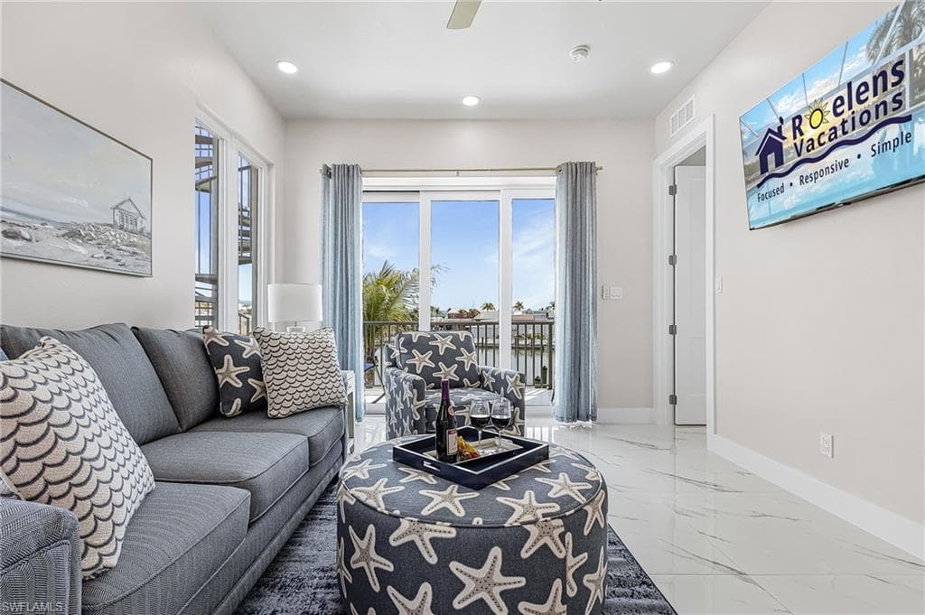 Bright living area featuring large sliding glass doors, recessed lighting, and tile flooring - Virtually Edited Image