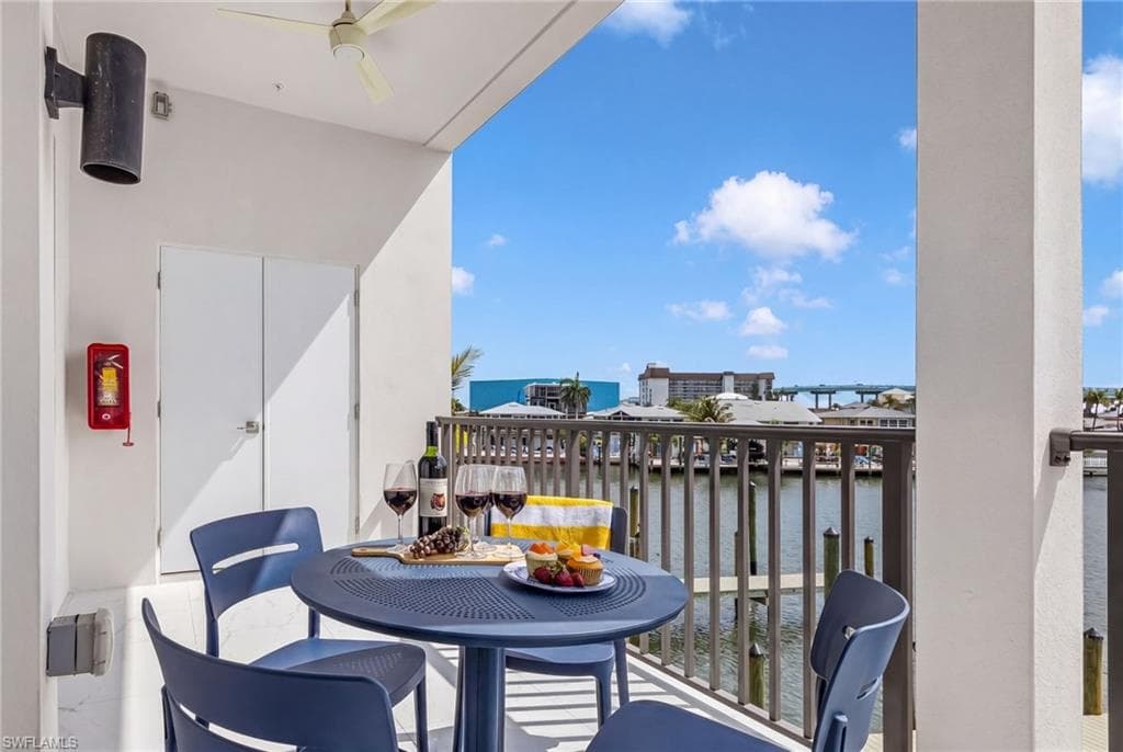 Outdoor balcony featuring a water backdrop with distant buildings and a bridge - Virtually Edited Image