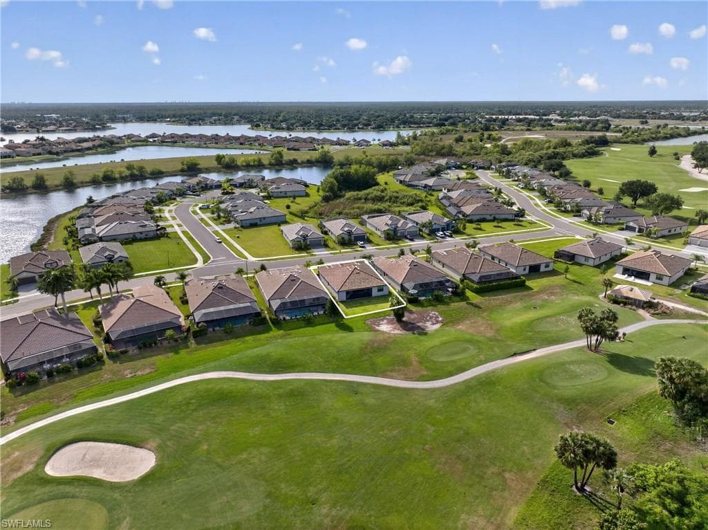Aerial perspective showcasing a residential community with golf course frontage