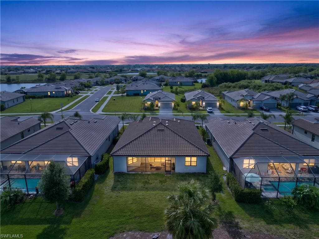 Aerial perspective showcasing a residential community with tiled-roof homes