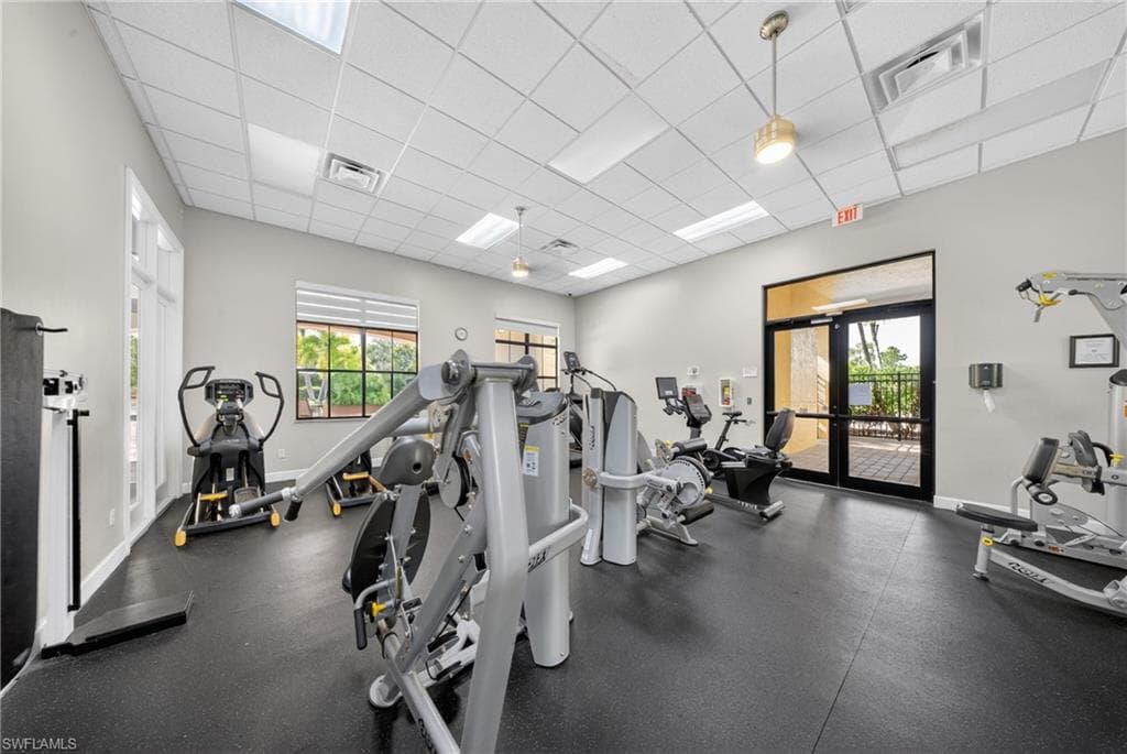 Fitness center featuring rubber flooring, recessed lighting, and multiple exercise machines
