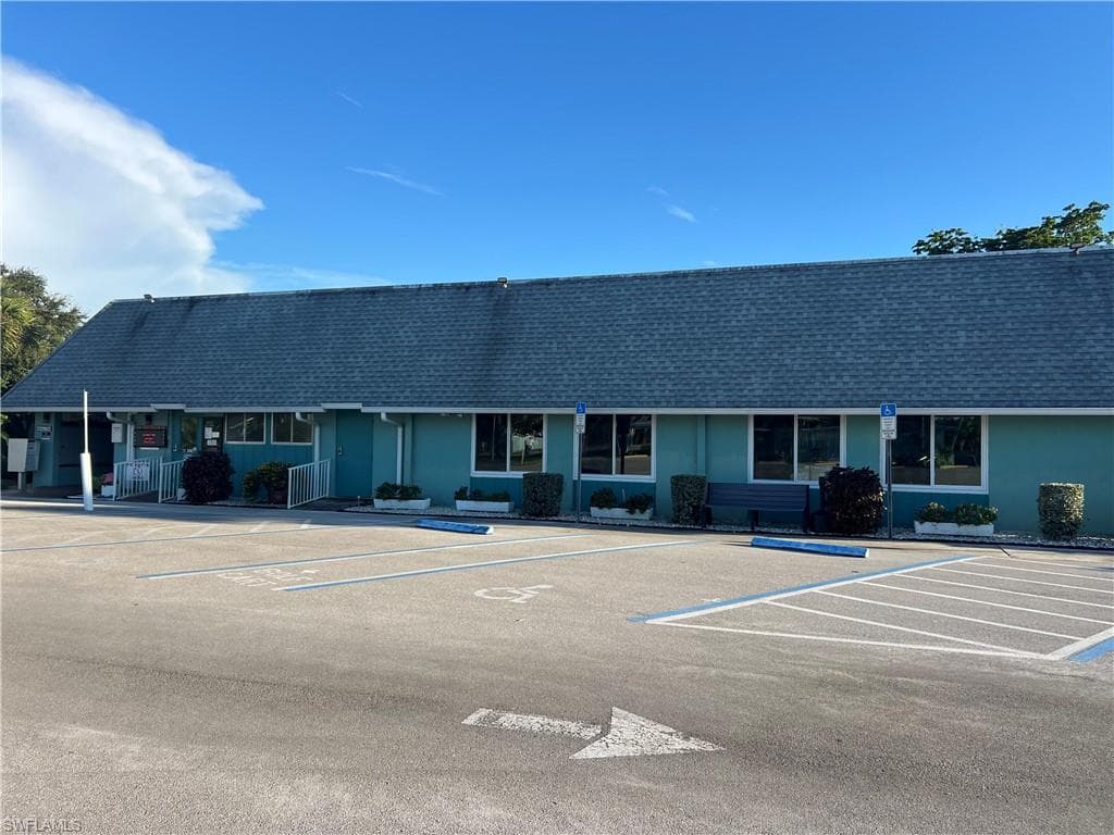 View of property with uncovered parking