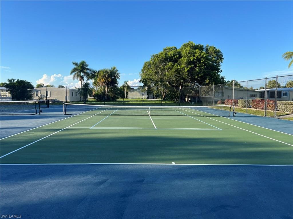 View of tennis court featuring community basketball court