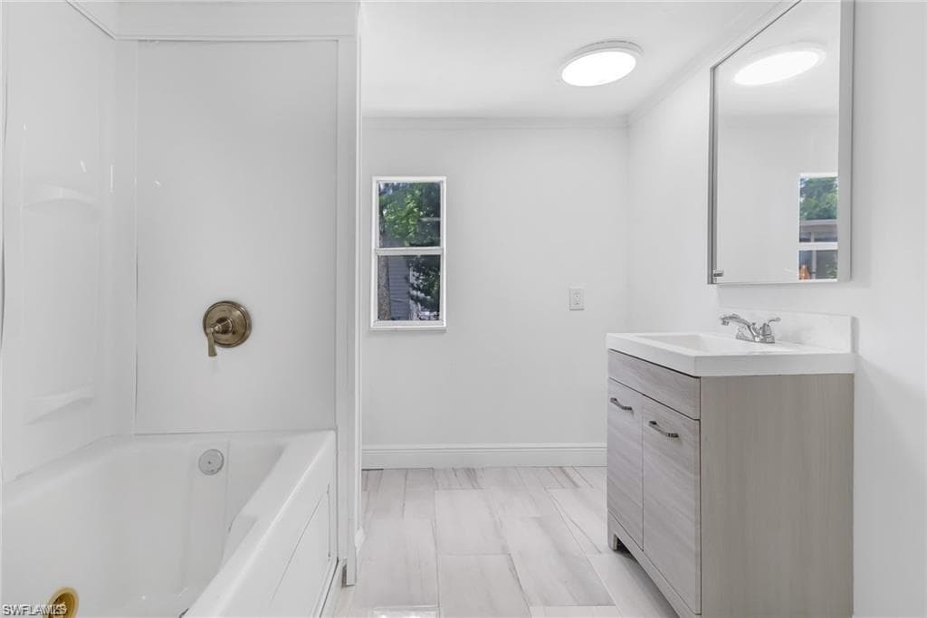 Full bathroom with vanity and shower combination